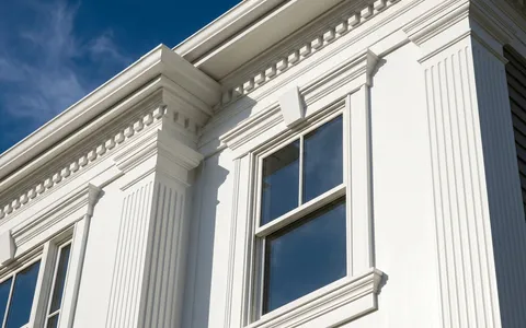 White PVC crown, casing and window trim on a home exterior