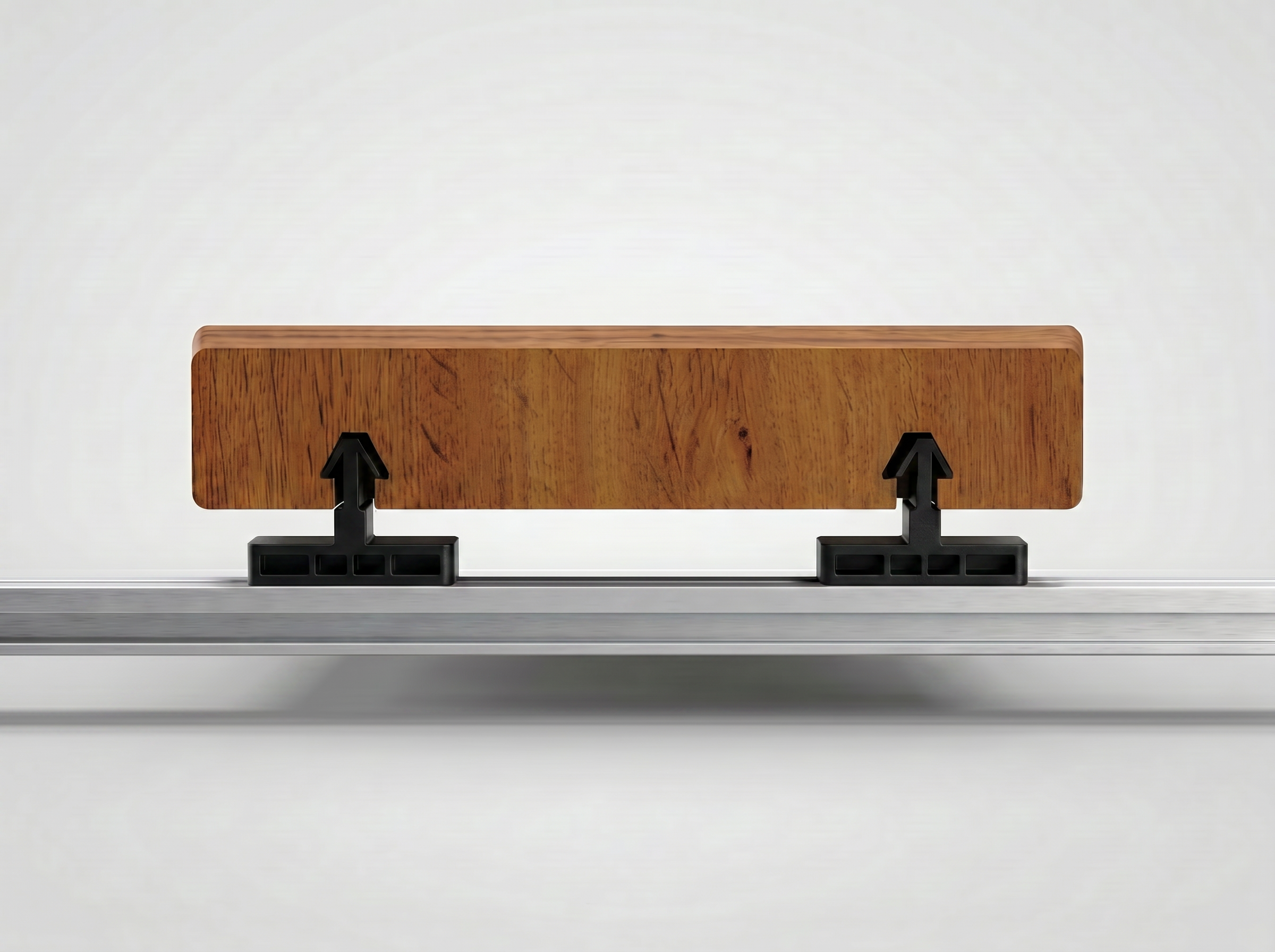 Walnut PVC deck board hovering above two InvisiClip hidden fasteners on an aluminum rail, grooves aligned with the clips