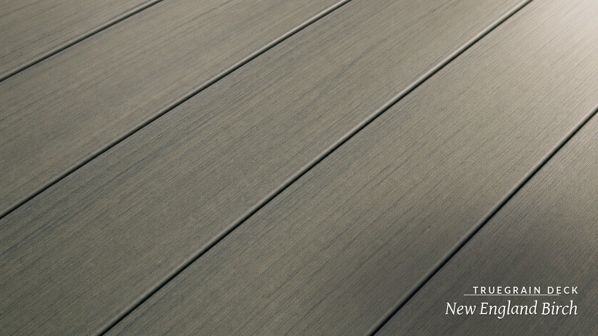 Realistic laminated wood-grain PVC deck boards in warm afternoon light