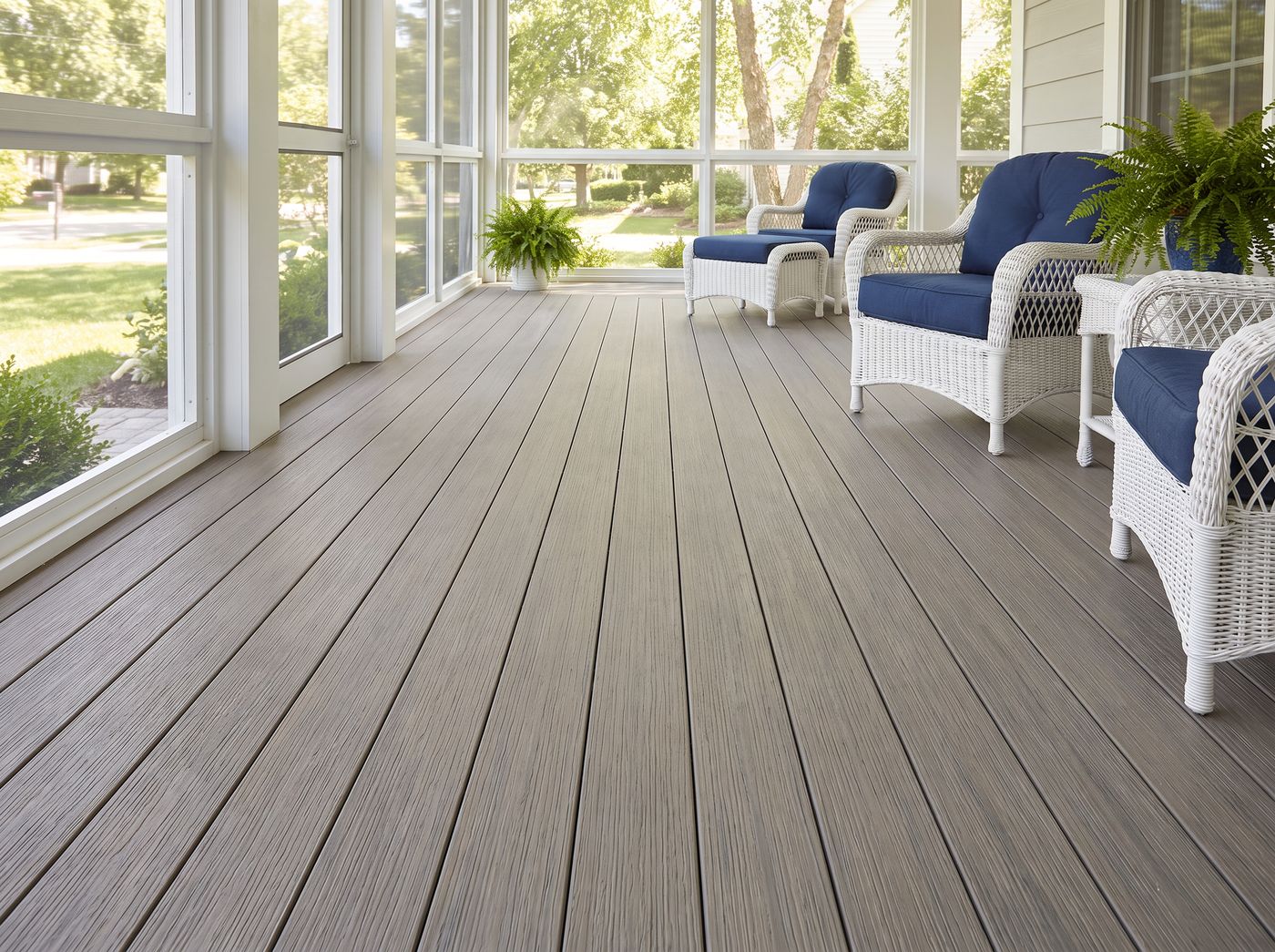 Beachwood PVC tongue and groove porch flooring in a coastal screened porch with wicker seating